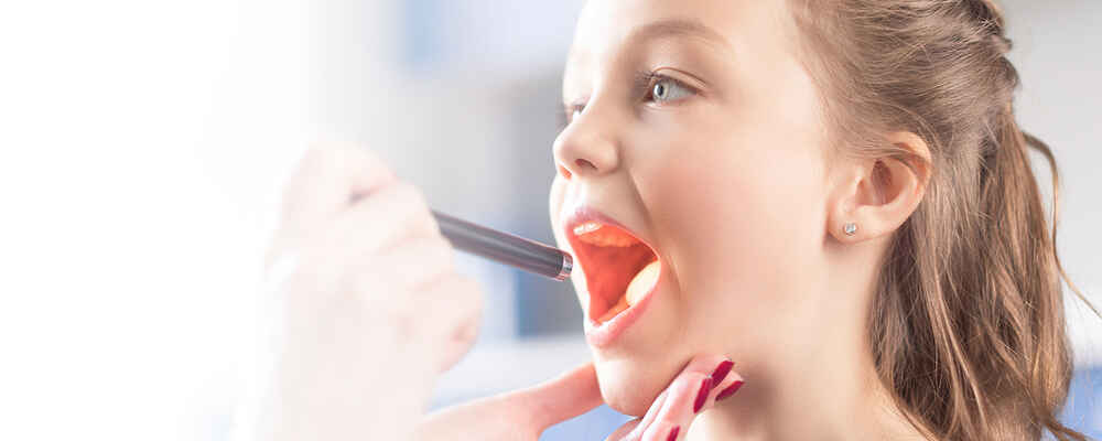 Doctor checking child's mouth